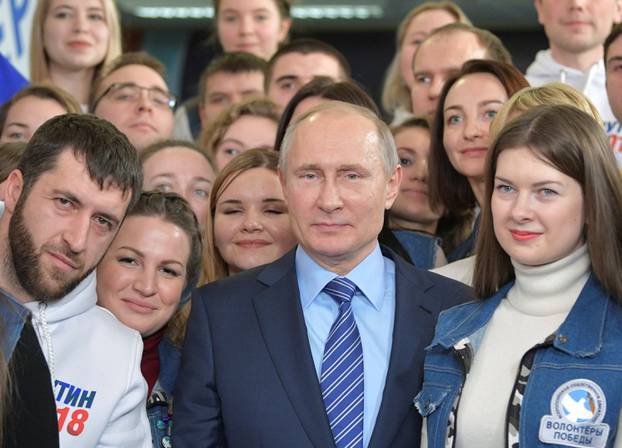 Russian President Vladimir Putin meets with volunteers at his campaign office for the upcoming presidential election in Moscow