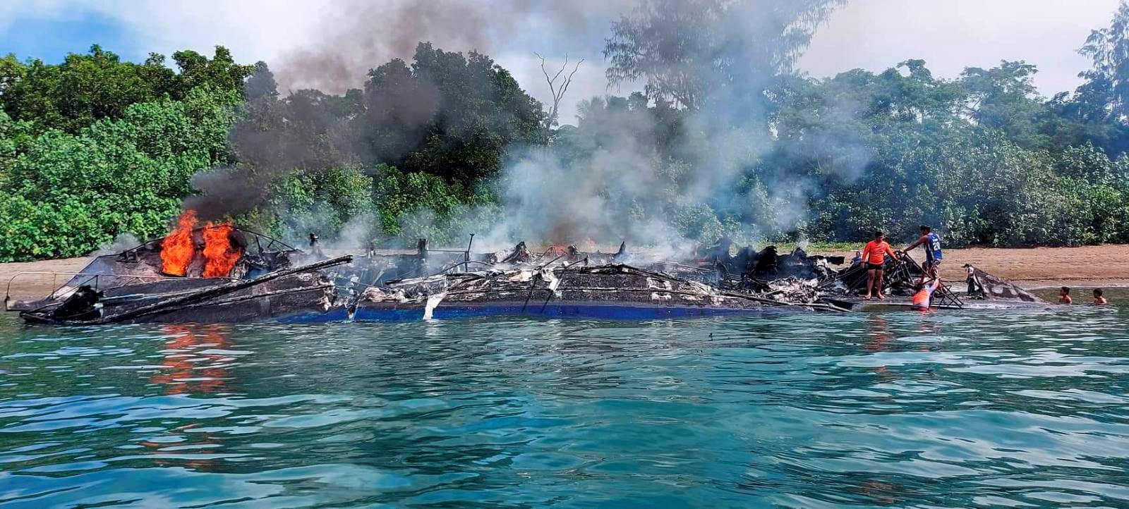 Smoke rises from a burning passenger vessel near Real