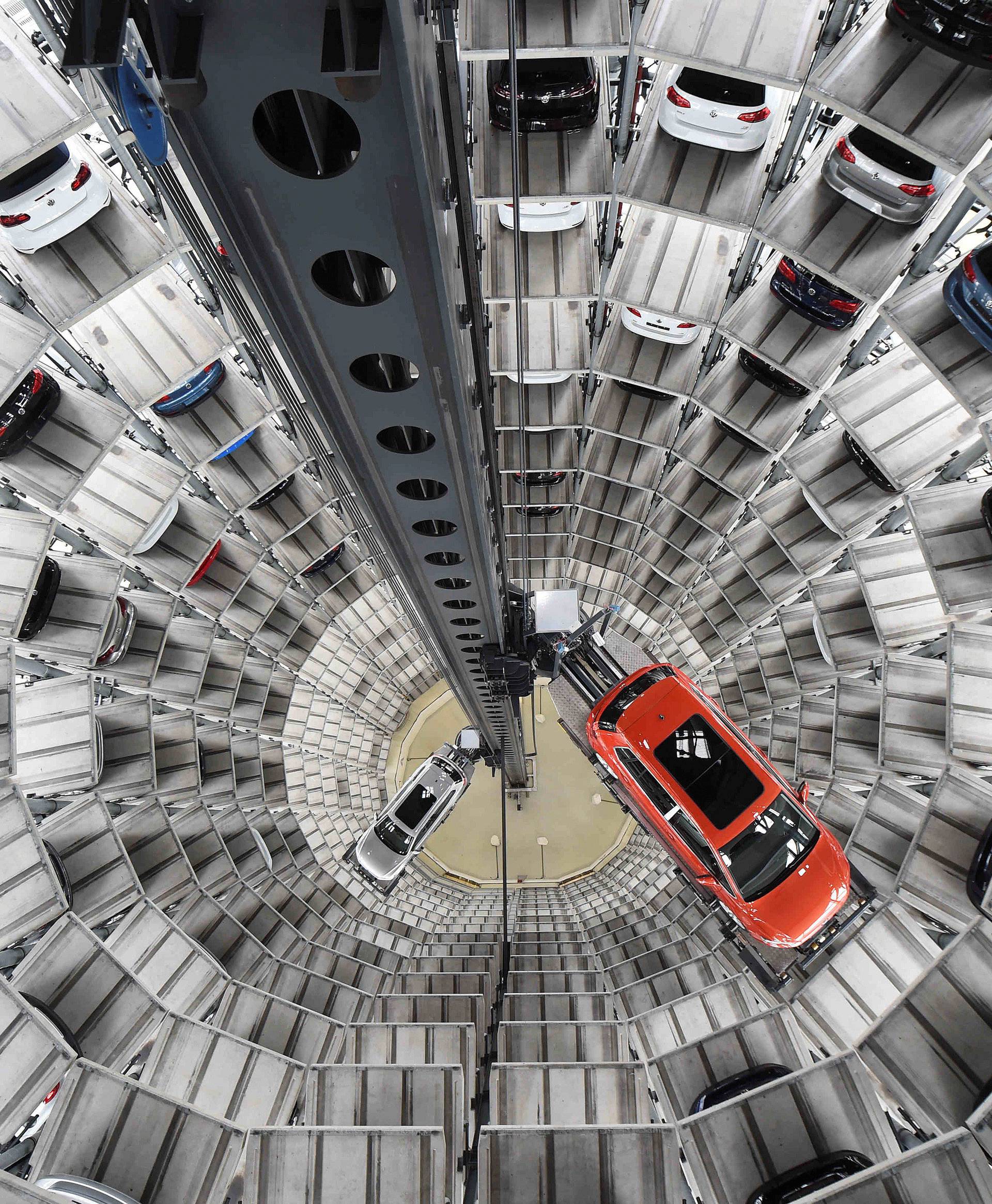 A VW Golf VII car and a VW Passat are loaded  in a delivery tower at the plant of German carmaker Volkswagen in Wolfsburg