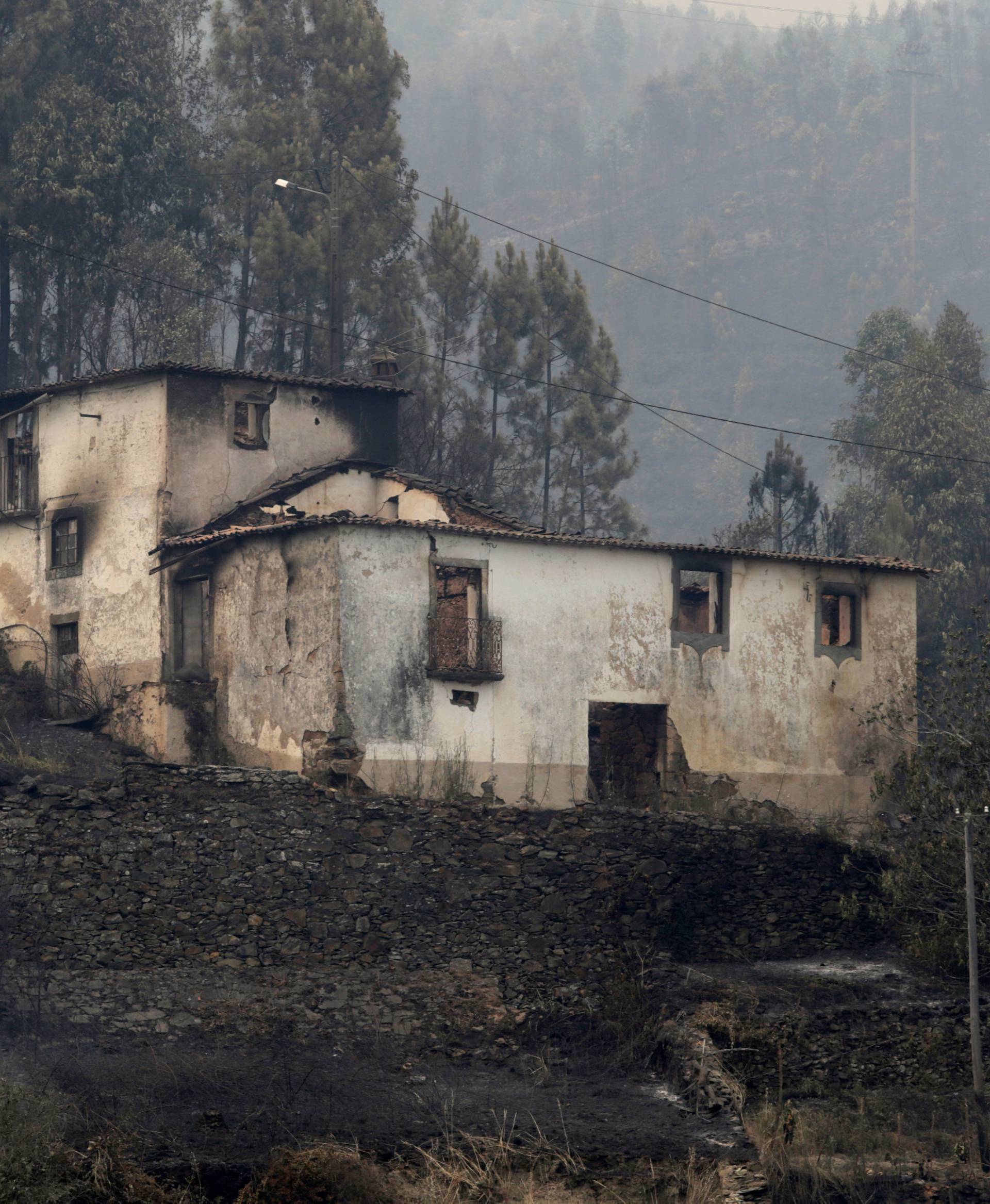 A burnt house is seen during a forest fire in Pedrogao Grande