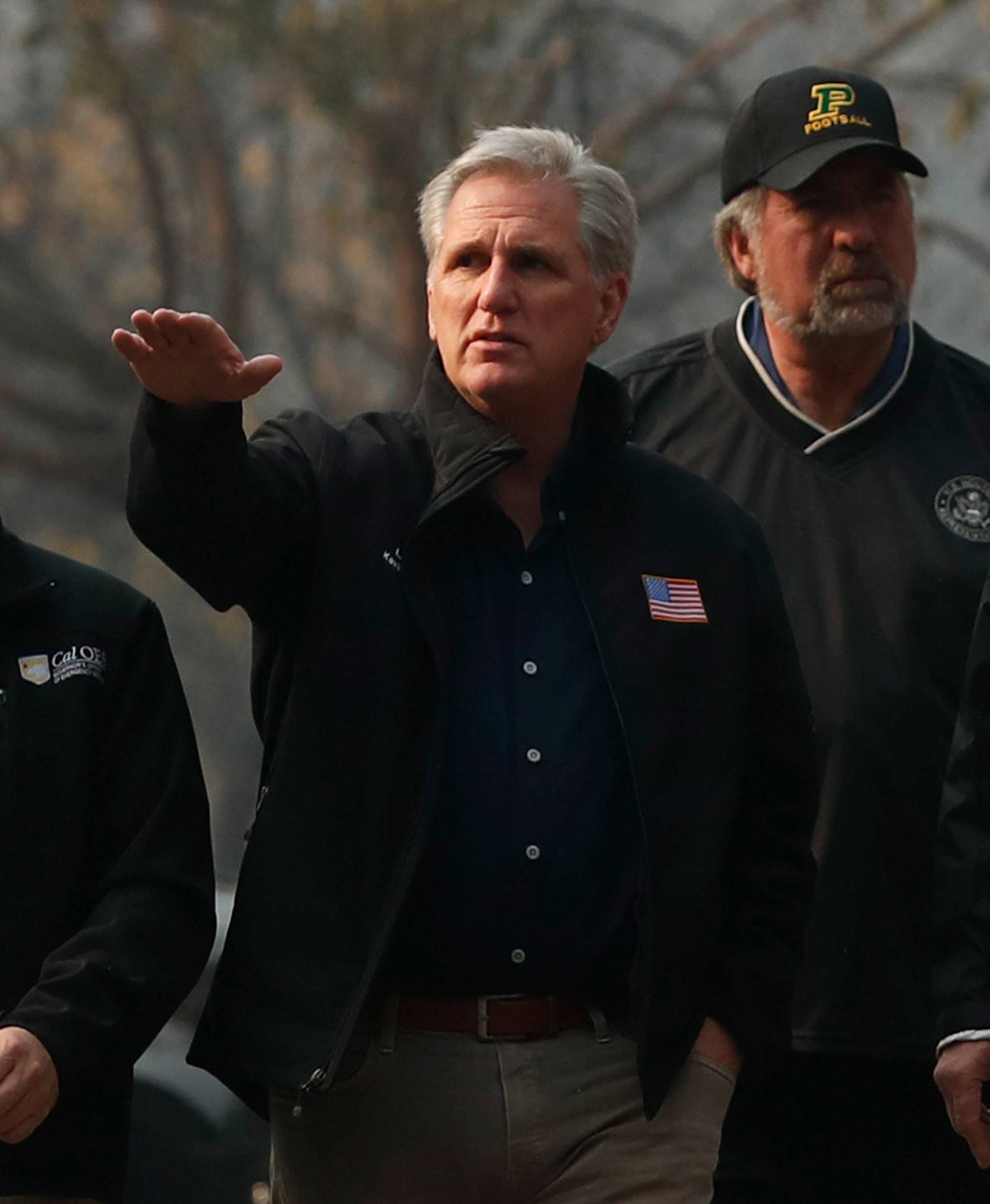 U.S. House Majority Leader Rep. Kevin McCarthy points while walking with U.S. President Donald Trump while visiting the charred wreckage of Skyway Villa Mobile Home and RV Park in Paradise California