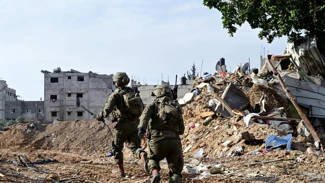Israeli soldiers operate at the Shajaiya district of Gaza city amid the ongoing conflict between Israel and the Palestinian Islamist group Hamas, in the Gaza Strip