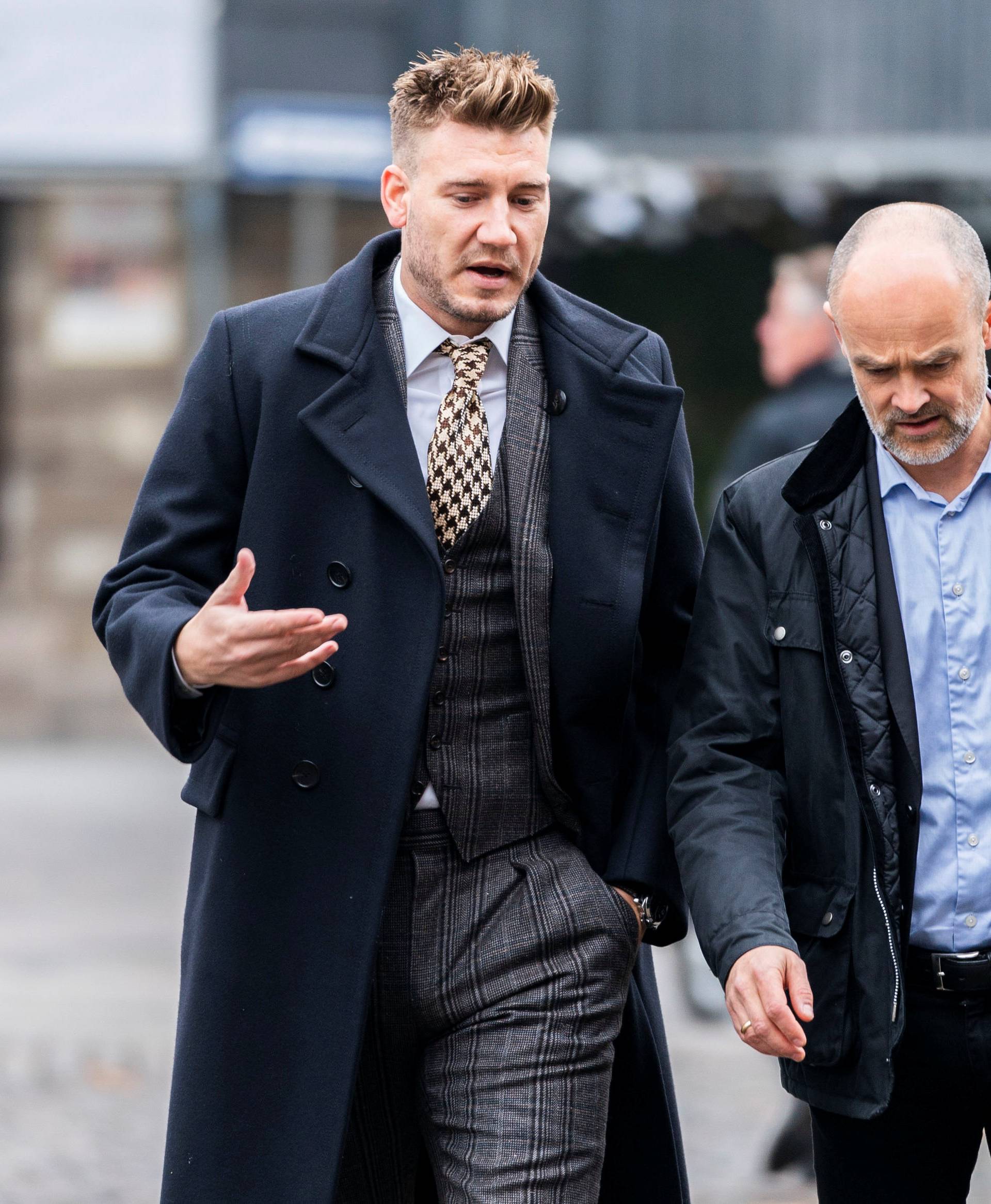 Denmark striker Nicklas Bendtner and lawyer Anders Nemeth arrive at the Copenhagen City Council