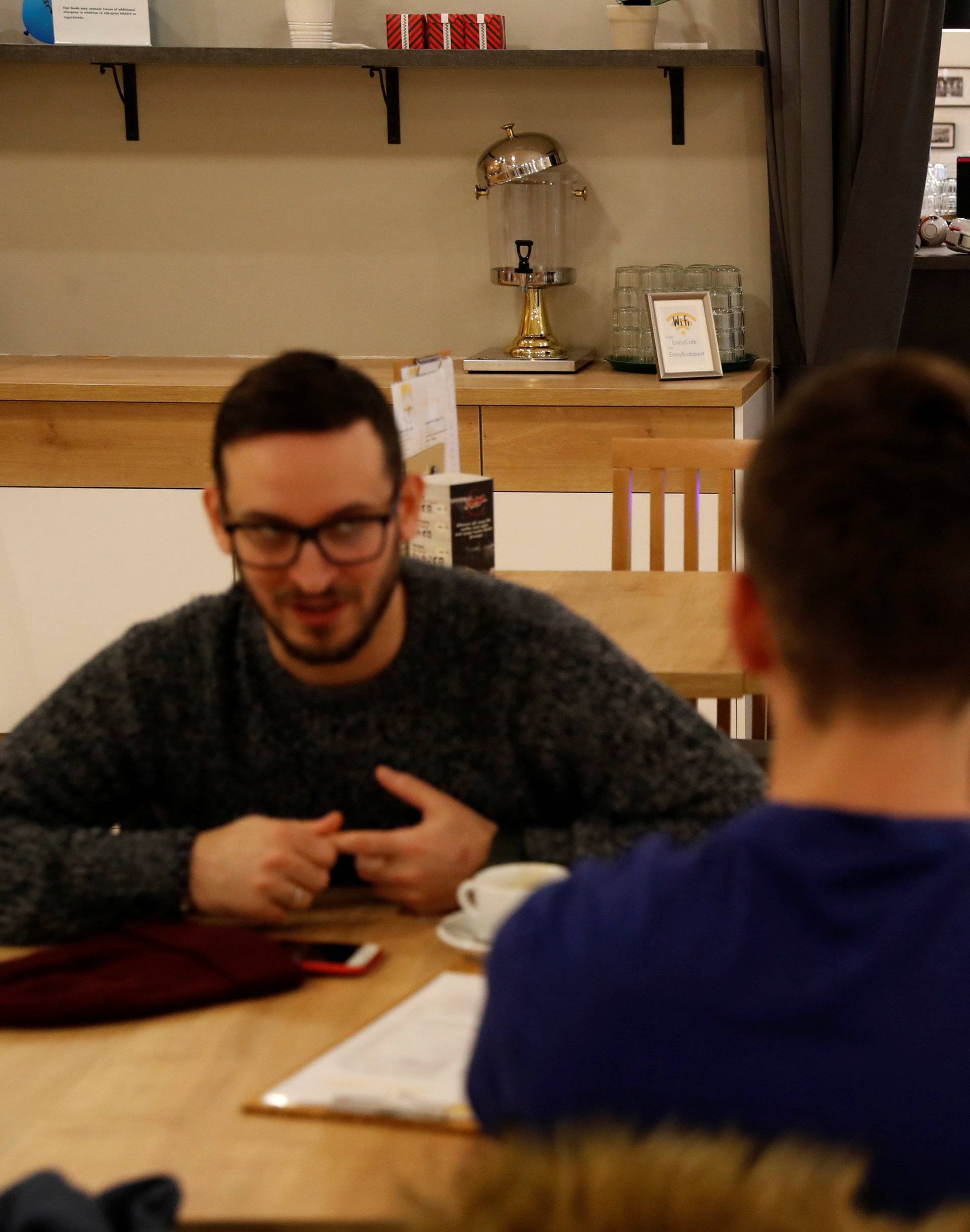 A robot waiter serves customers at a cafe in Budapest