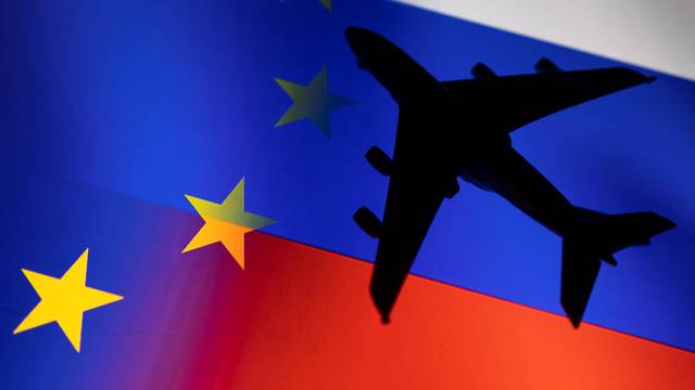 Illustration shows a model airplane displayed on EU and Russian flags