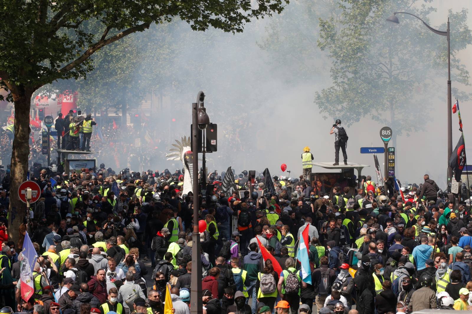 People including protesters wearing yellow vests gather before the start of the traditional May Day labour union march in Paris