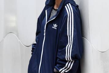 EXCLUSIVE: Anna Kournikova is dressed down in an Adidas jacket and Croc's rain boots as she waits for her car in Miami