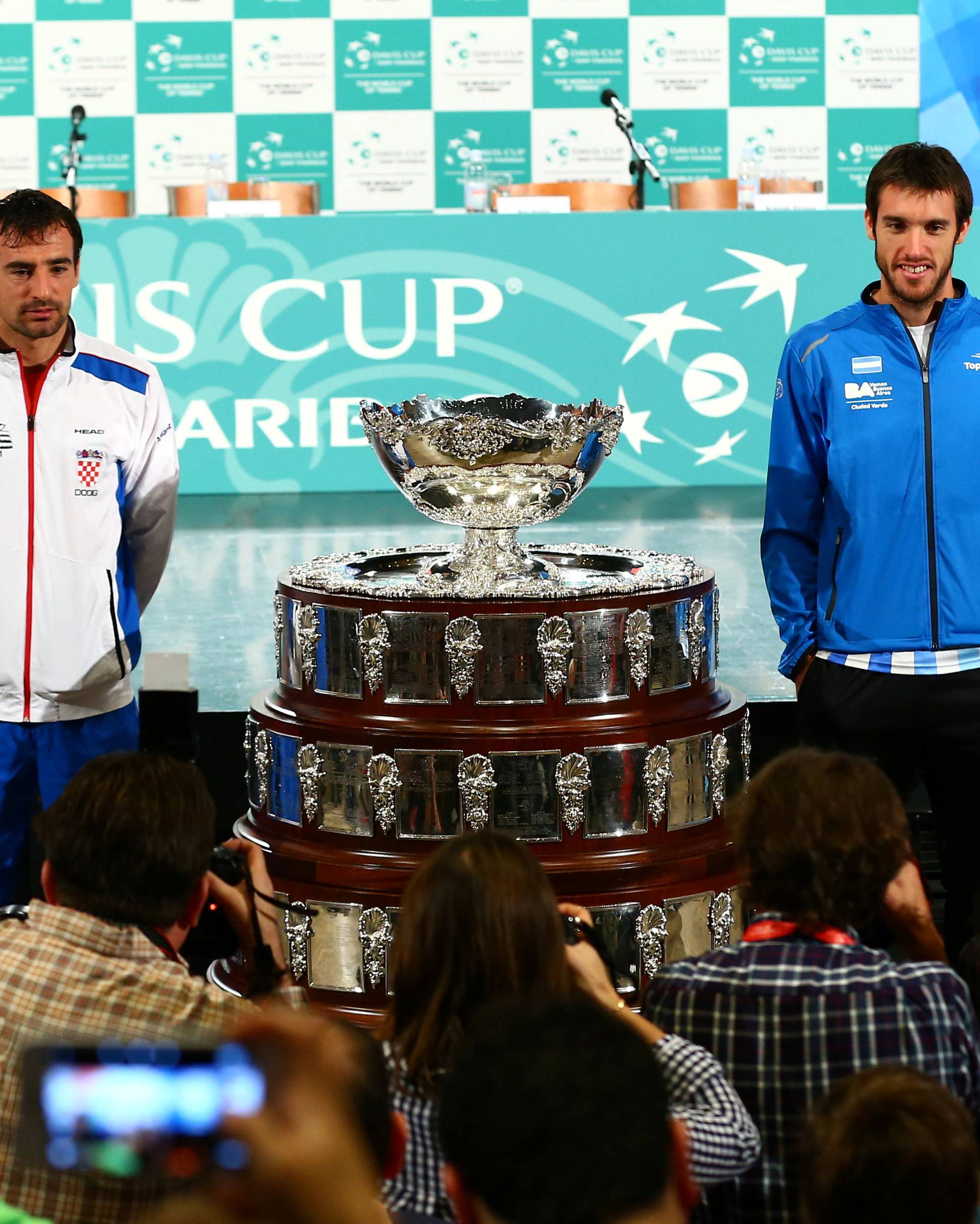 Croatia's tennis team players Franko Skugor and Ivan Dodig and Argentina's tennis team players Leonardo Mayer and Guido Pella pose for a picture after the official draw for their Davis Cup finals in Zagreb