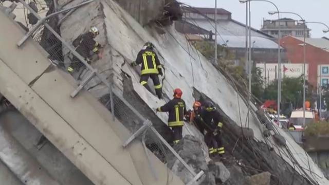 Rescue workers are seen at the collapsed Morandi Bridge in the Italian port city of Genoa