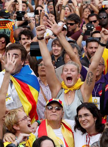 People celebrate as the Catalan regional parliament voted to declare independence from Spain in Barcelona