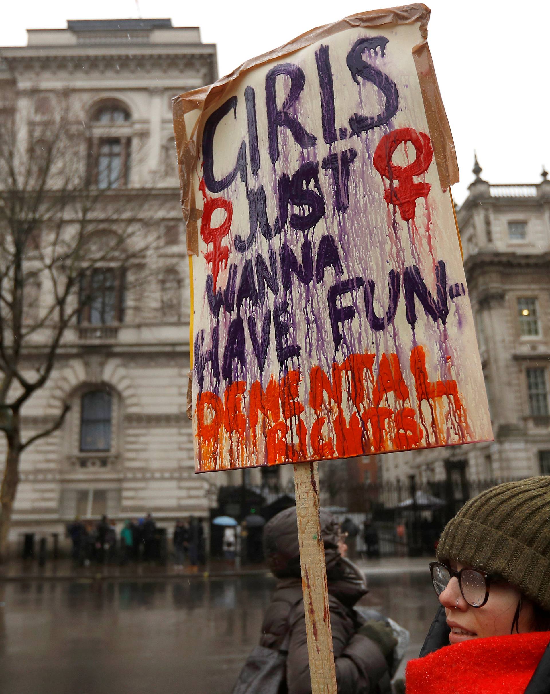 A demonstrator attends a Times Up protest supporting womens rights in London