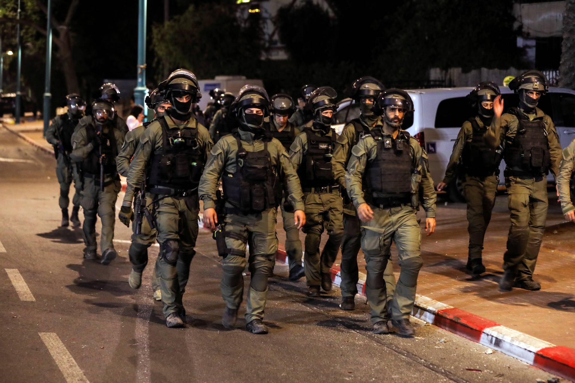 Israeli security force members patrol during a night-time curfew following violence in the Arab-Jewish town of Lod