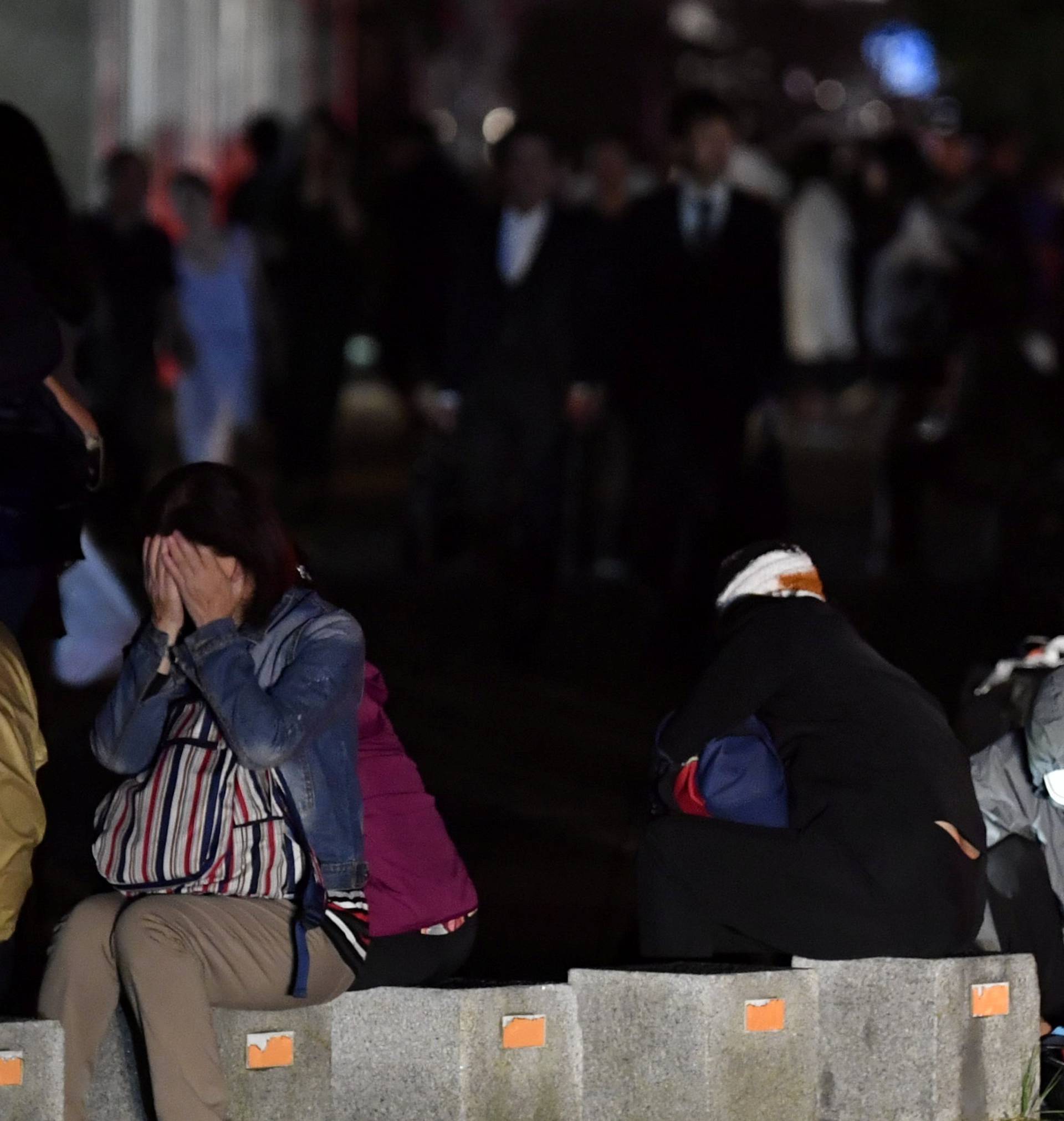 People react during blackout after a powerful earthquake hit the area in Sapporo