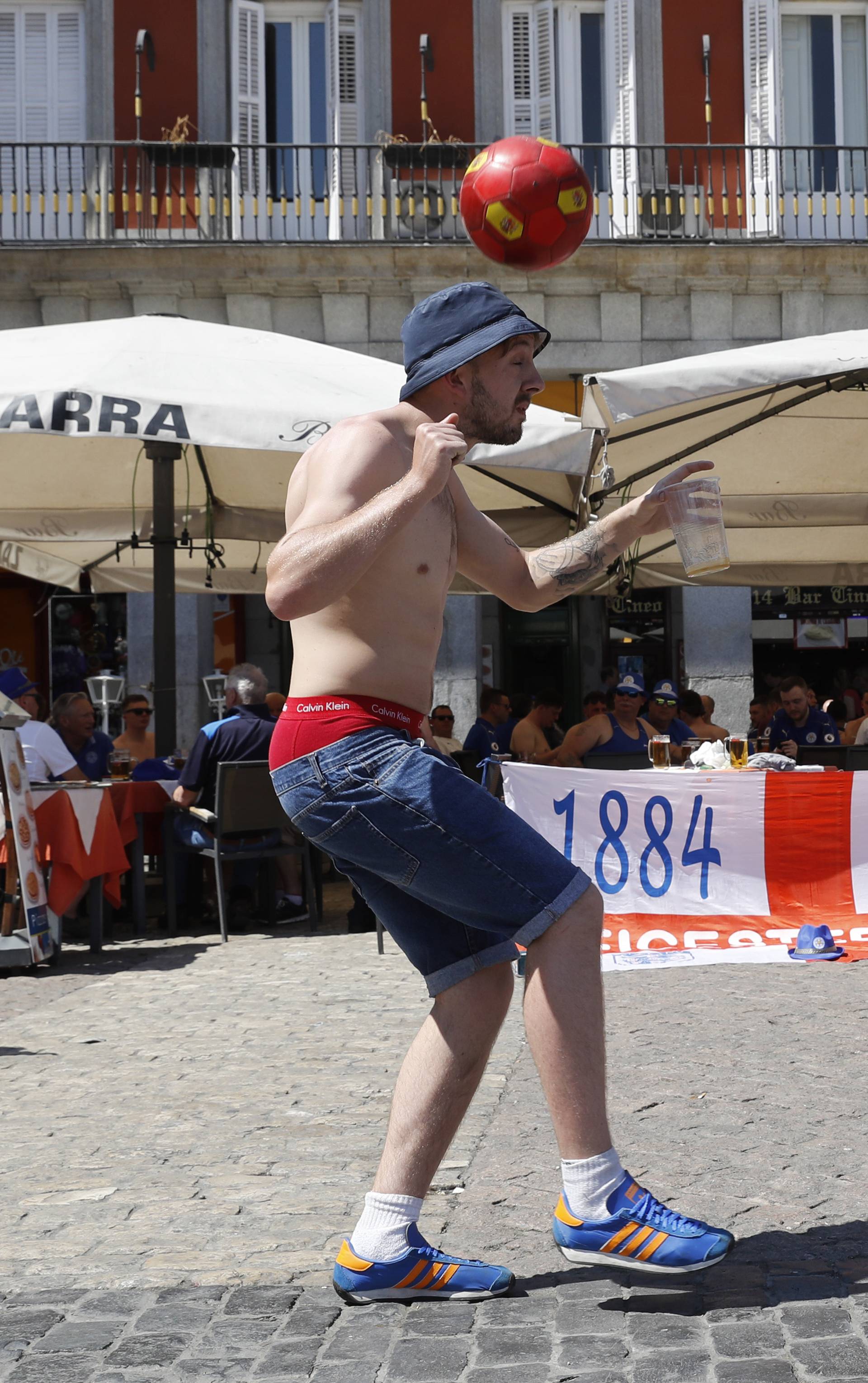 Fans play football in the Plaza Mayor before the match