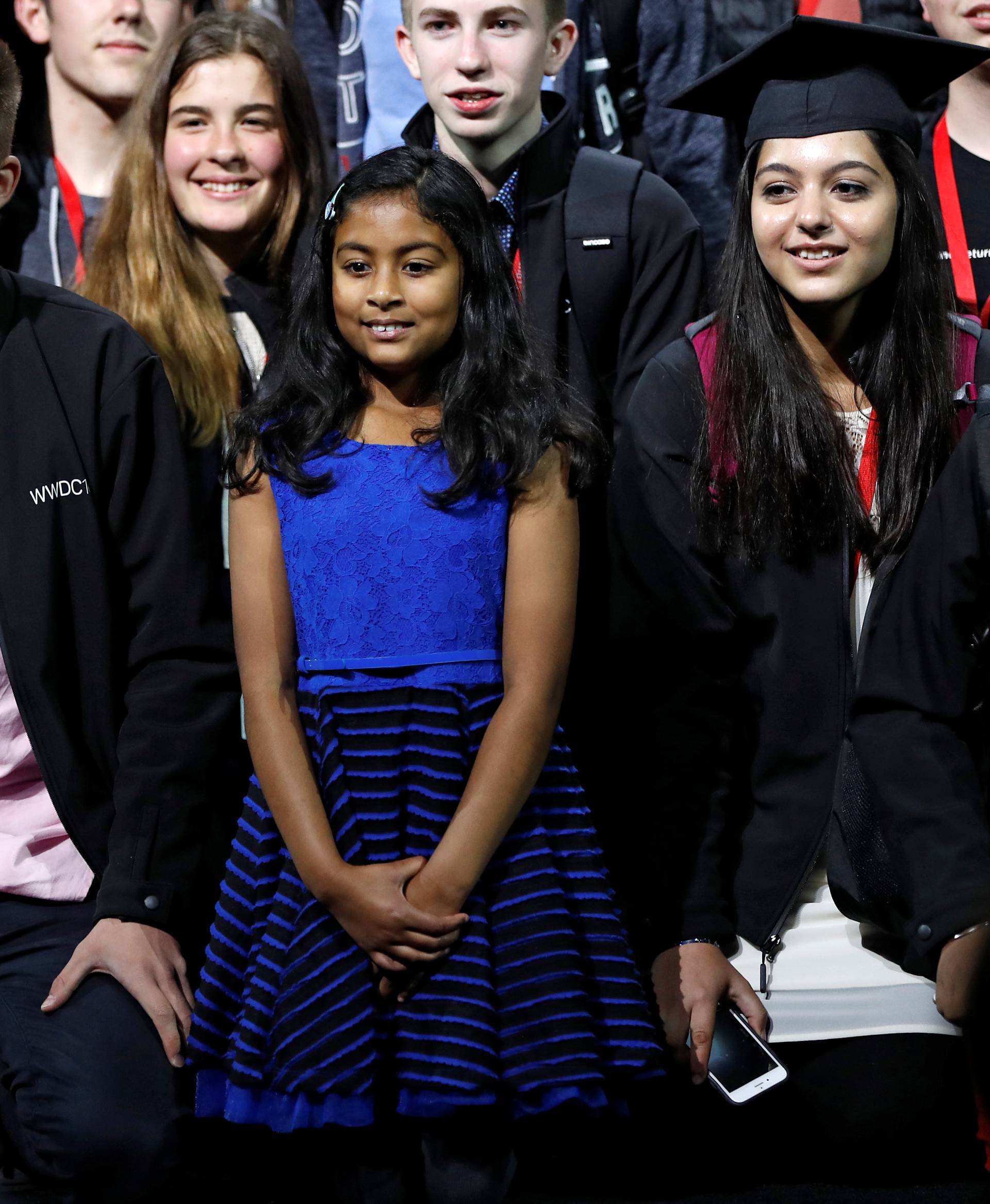 Nine-year-old Anvitha Vijay, the youngest developer to attend the Apple World Wide Developers Conference, poses for a group photo after the keynote in San Francisco