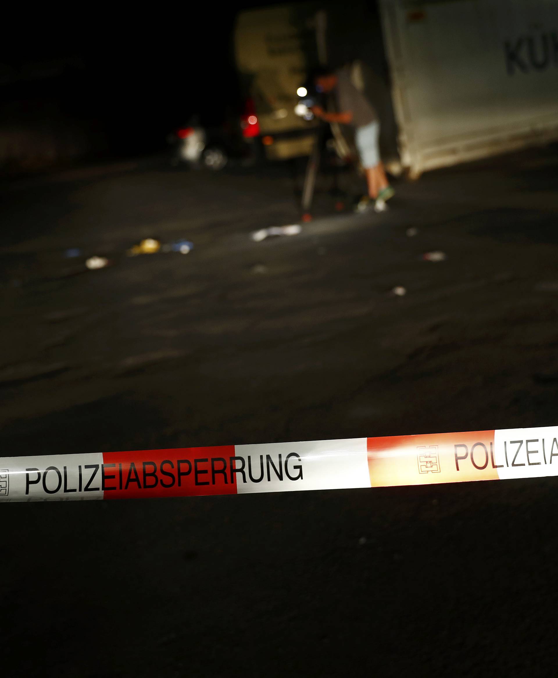 Cameraman films at the scene where a man was shot dead by the police after attacking passengers on a train with an axe near the city of Wuerzburg