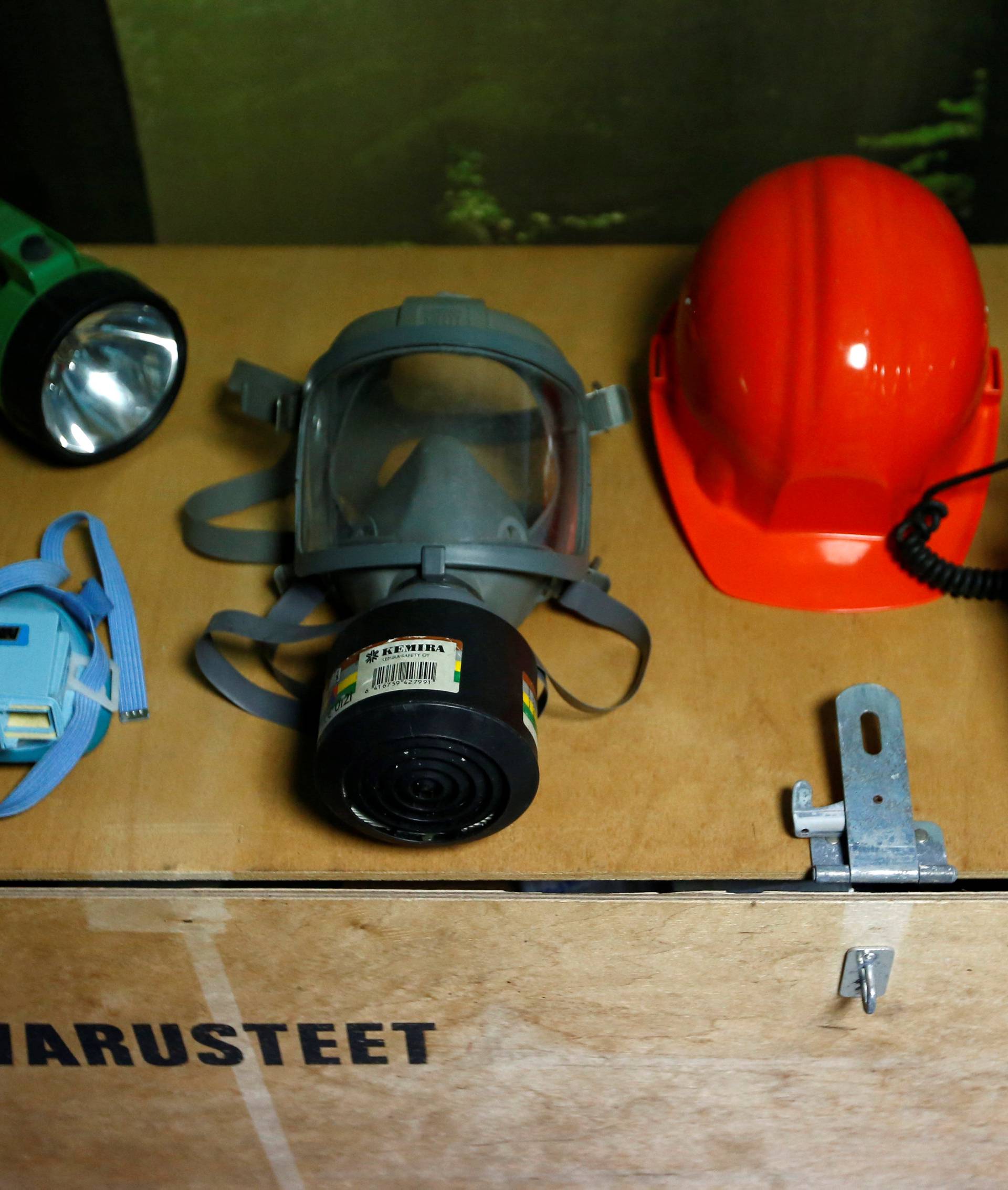 A gas mask, a Geiger counter and emergency goods are seen in Shelter Co.'s nuclear shelter model room in Osaka
