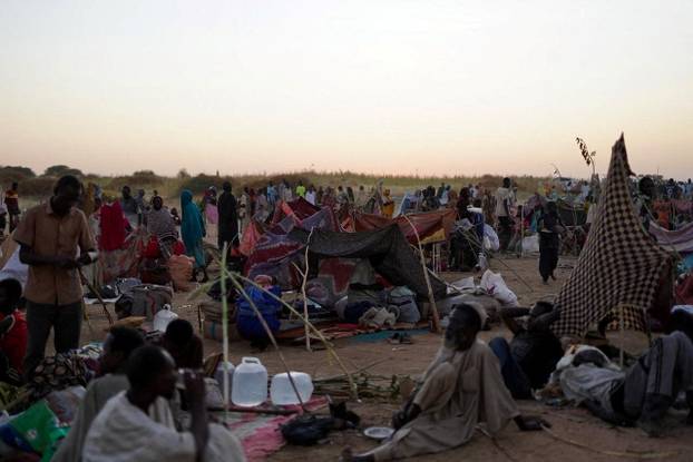 Displaced people, who fled from al-Fashir, spend time at a camp in Tawila