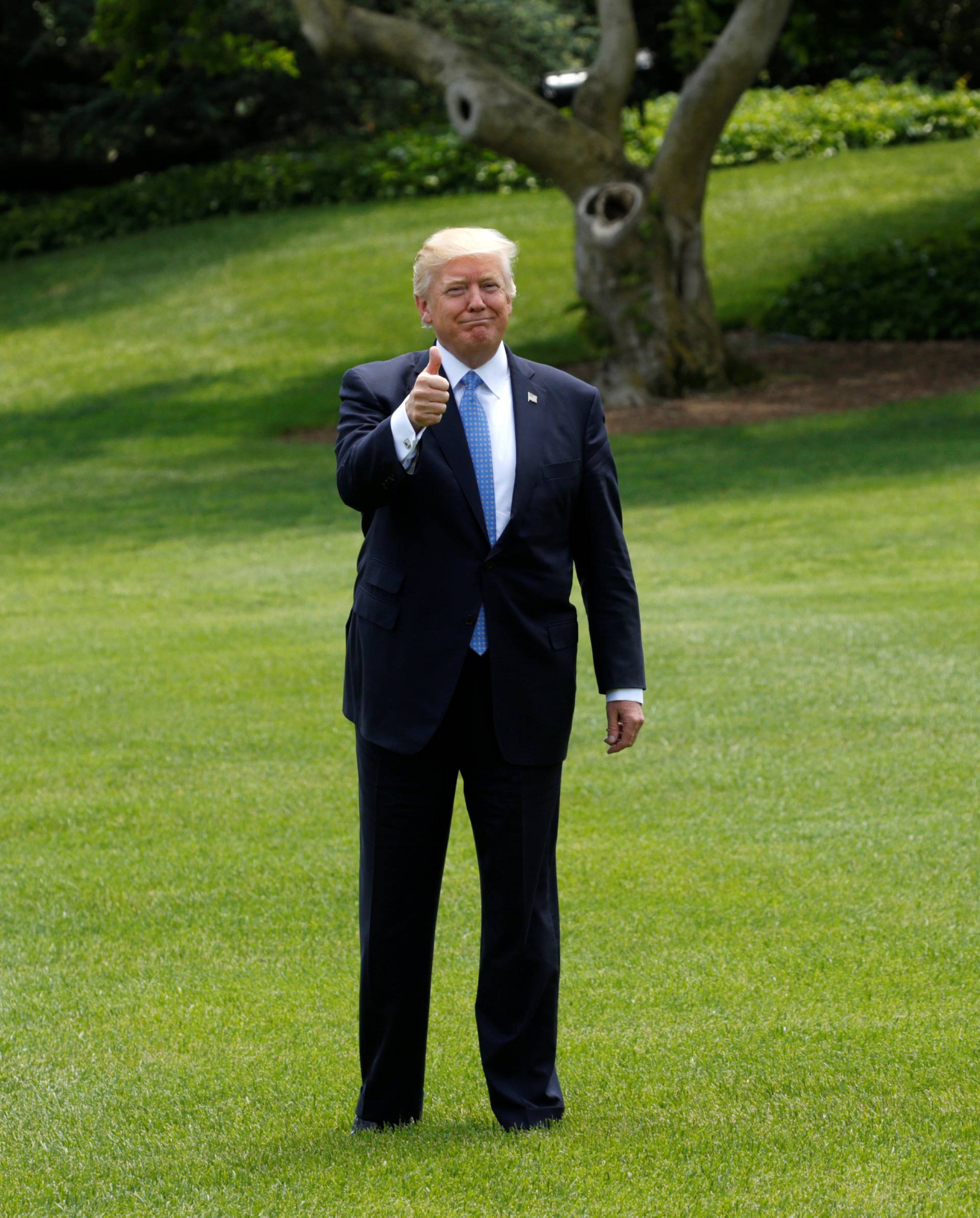 U.S. President Trump stops to give a thumbs up as he departs the White House to embark on a trip to the Middle East and Europe, in Washington