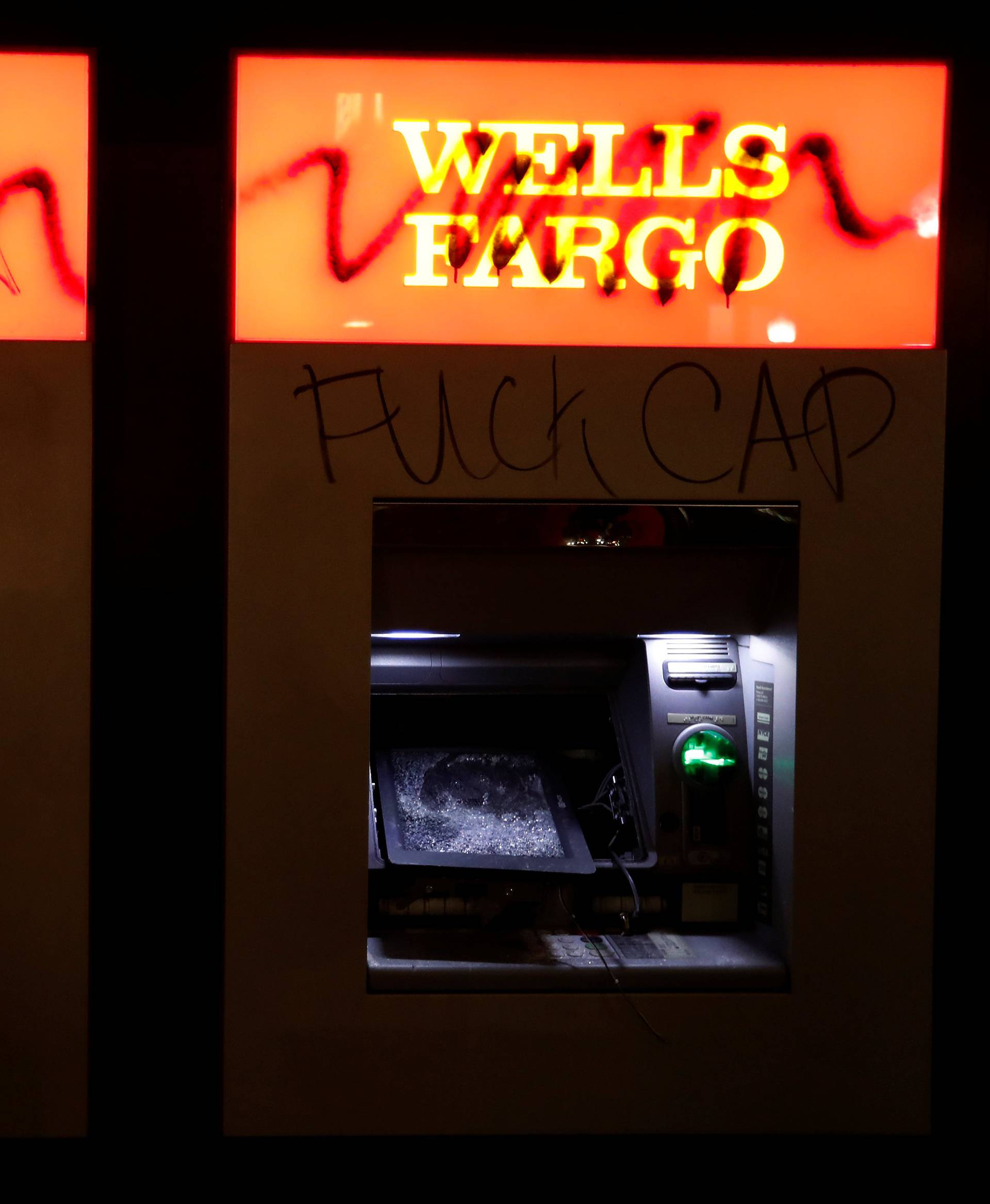 Vandalized ATMs are seen at a Wells Fargo bank after a student protest turned violent at UC Berkeley during a demonstration over right-wing speaker Milo Yiannopoulos, who was forced to cancel his talk, in Berkeley, California