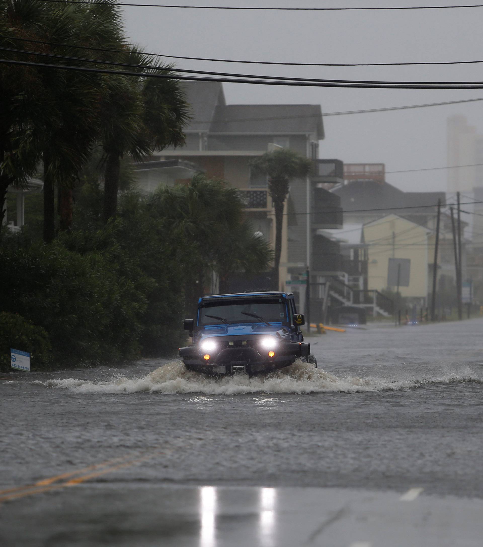 A vehicle navigates a flooded Ocean Boulevard during Hurricane Florence in North Myrtle Beach