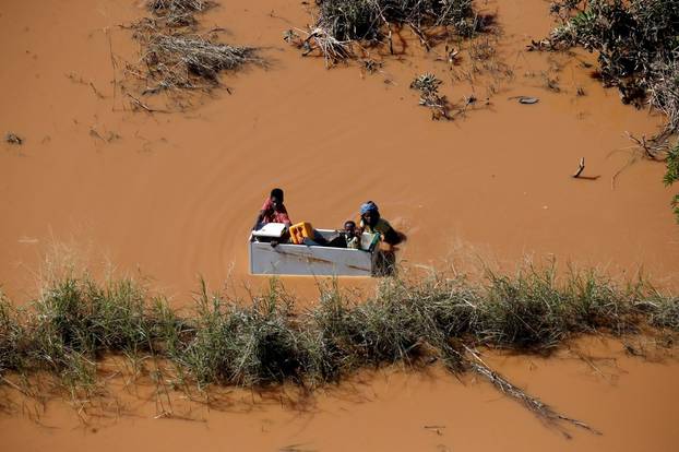 A child is transported on a fridge during floods after Cyclone Idai, in Buzi, outside Beira