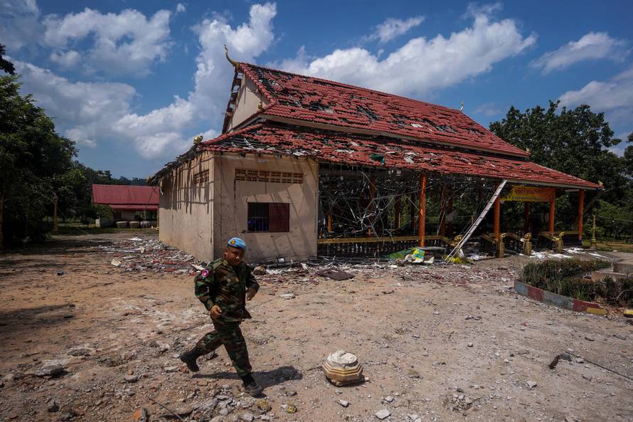 FILE PHOTO: A Cambodian soldier walks past a damaged building during a visit of delegation of foreign diplomats to inspect a damaged area along the Thailand-Cambodia's border