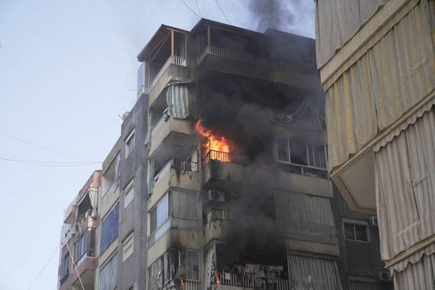 Flames engulf a building following an Israeli air strike in Beirut