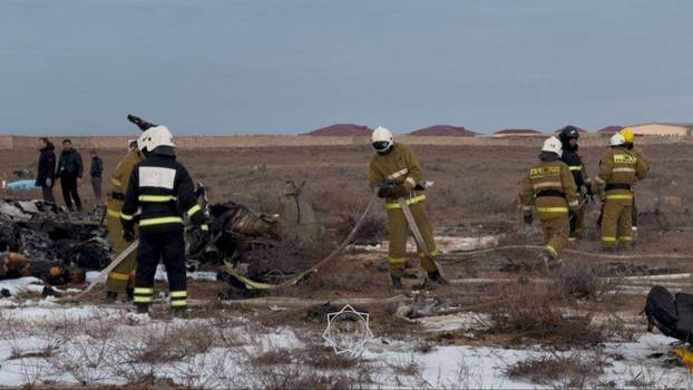 Emergency specialists work at the crash site of a passenger plane near Aktau