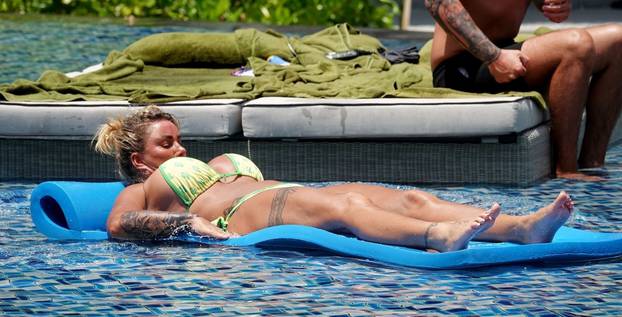 *PREMIUM-EXCLUSIVE* *MUST CALL FOR PRICING* Katie Price AKA Jordan pictured showcasing her bikini body while relaxing by the pool with boyfriend Carl Woods during their holiday in Thailand.