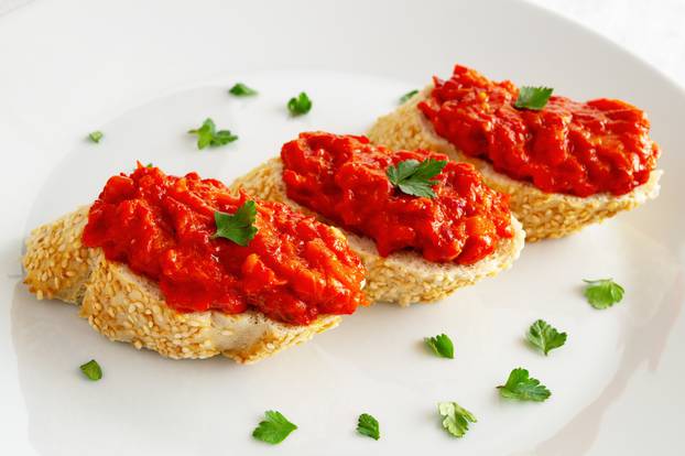 sandwiches with roasted bell pepper spread decorated with cilantro