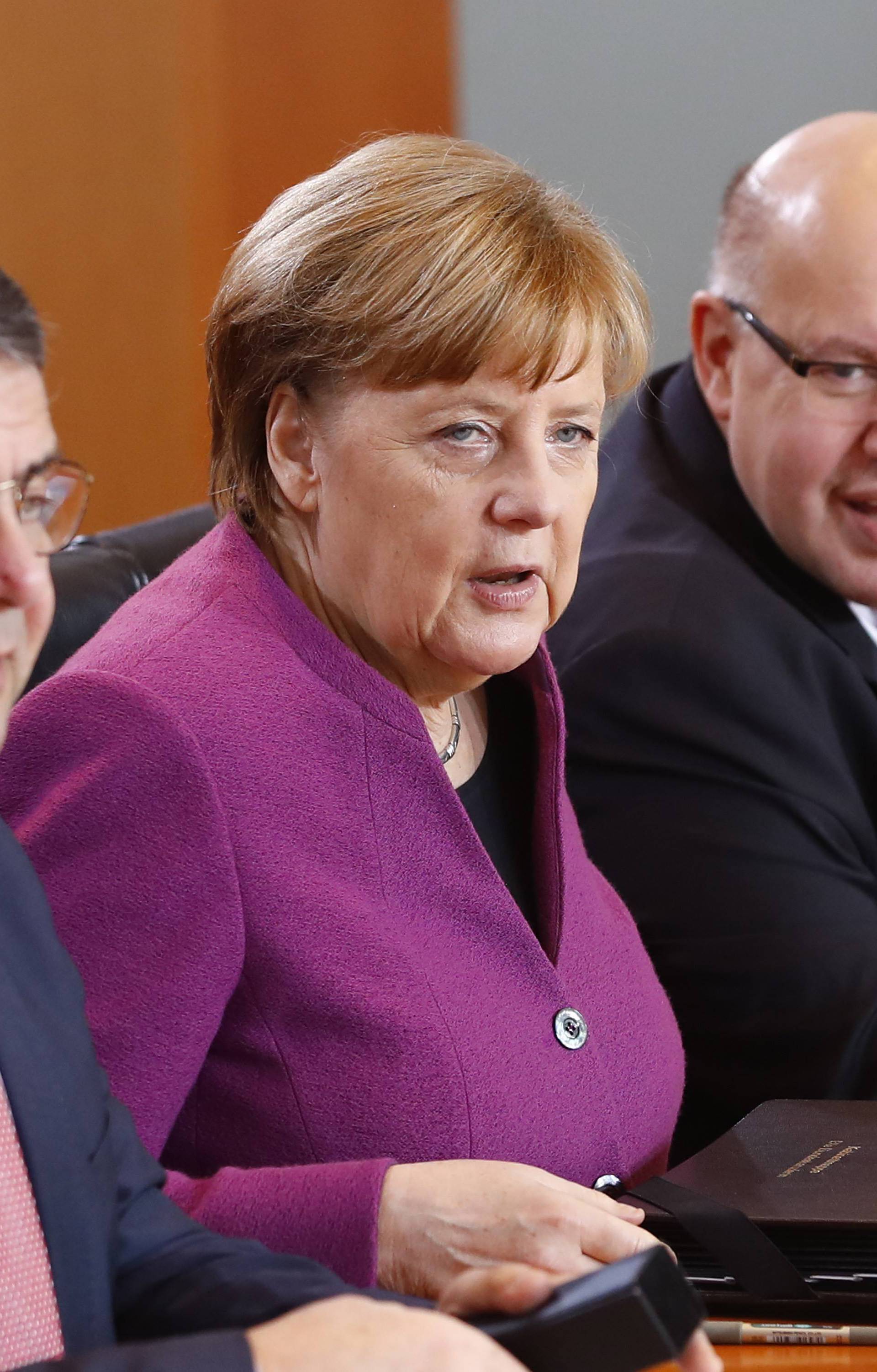 German Foreign Minister Sigmar Gabriel, Chancellor Angela Merkel and Chancellery minister Peter Altmaier attend the weekly cabinet meeting at the Chancellery in Berlin