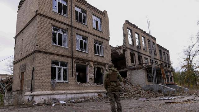 FILE PHOTO: A police officer stands in front of a damaged building in Avdiivka