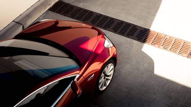 A Tesla Model 3 sedan is seen in this undated handout image as the car company handed over its first 30 Model 3 vehicles to employee buyers at the companyâs Fremont facility