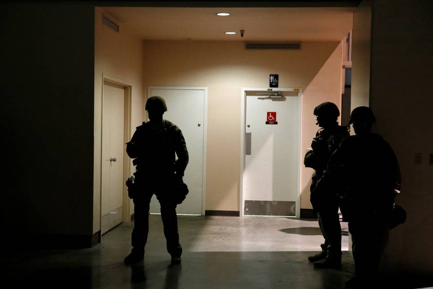 Police officers stand guard backstage after U.S. Republican presidential nominee Donald Trump was hustled off the stage by security agents at a campaign event following a perceived threat in the crowd, in Reno, Nevada