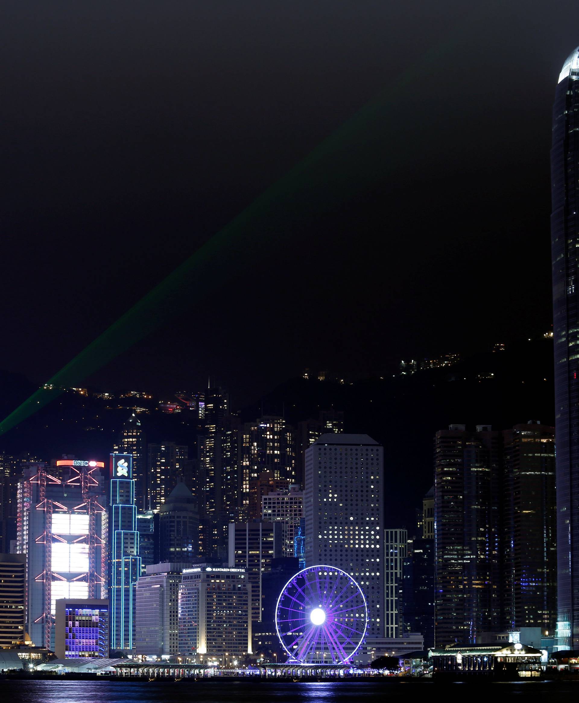 Laser light beams as buildings in the financial Central district are lit up before Earth Hour in Hong Kong