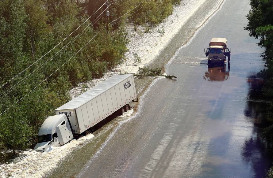 A tractor trailer sits on its side after being washed over Route 301 from flood waters caused by Hurricane Florence near Dillon, South Carolina