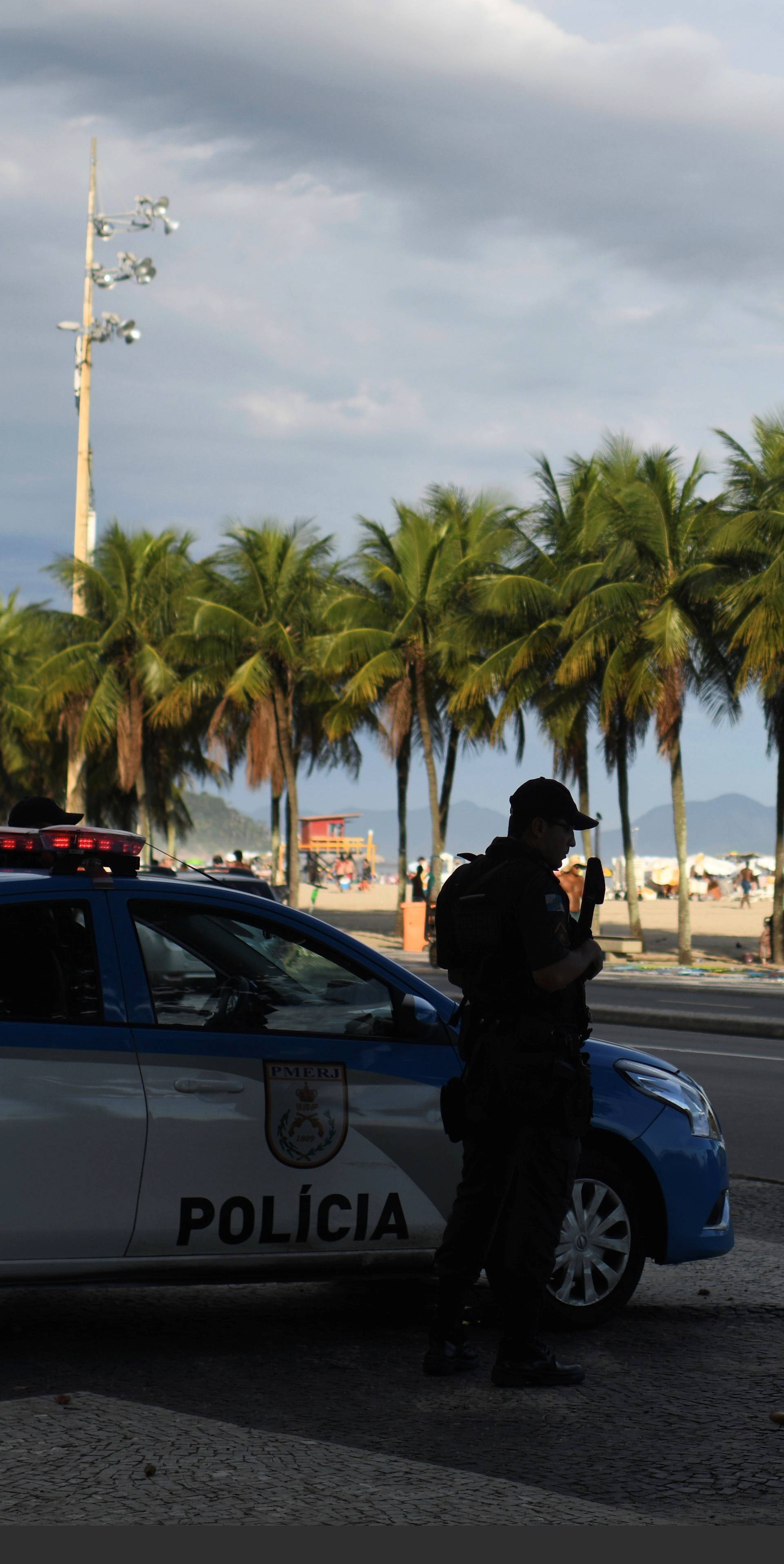 A police officer stands guard at the Copacabana beach in Rio de Janeiro