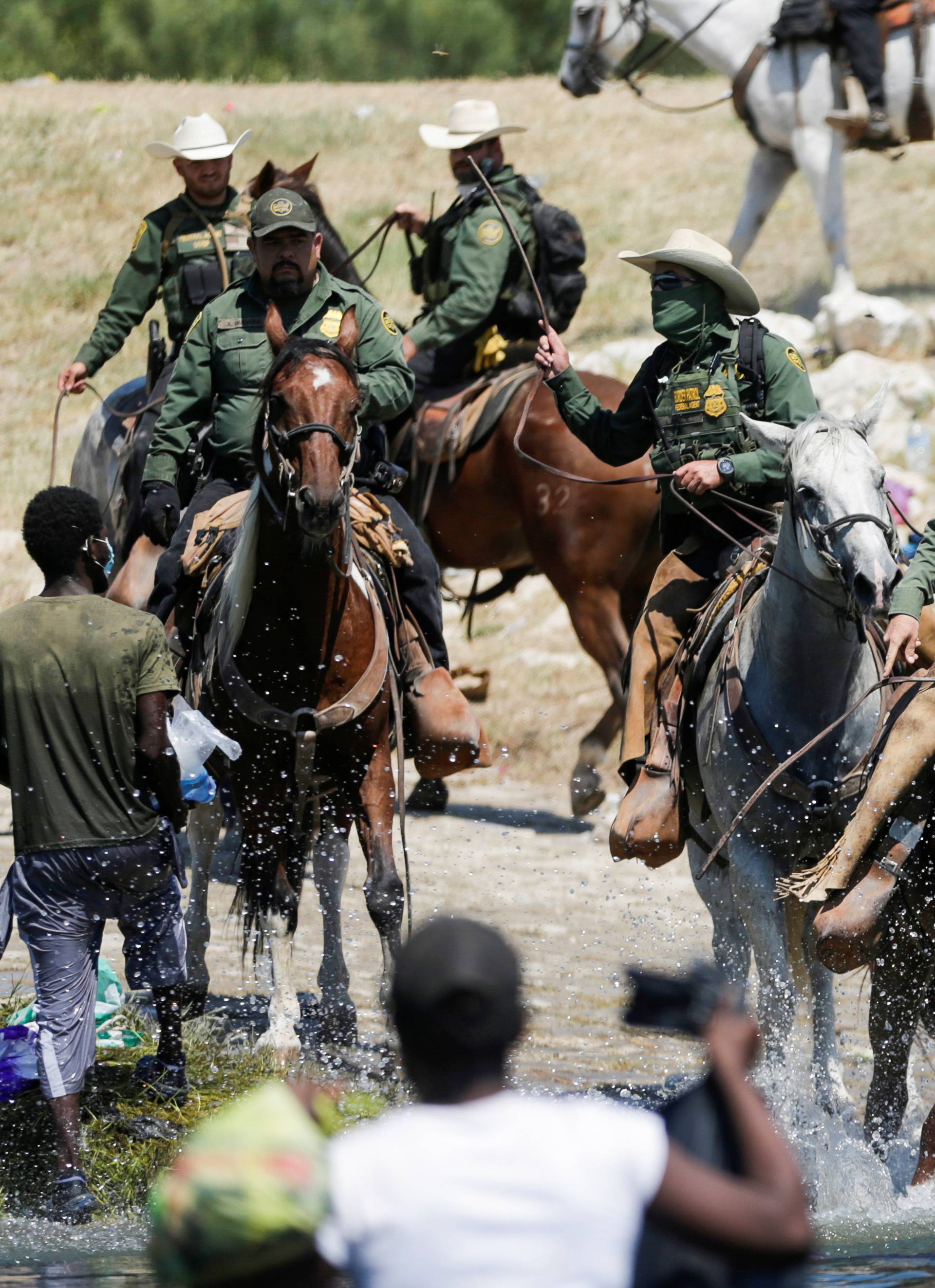 Migrants collecting food try to evade law enforcement at the U.S.-Mexico border