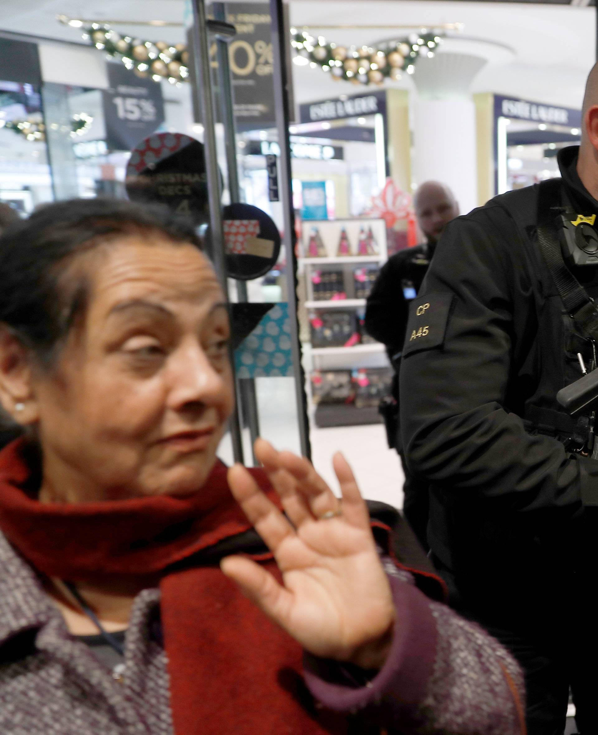 Armed police officers mix with shoppers in an Oxford Street store, in London