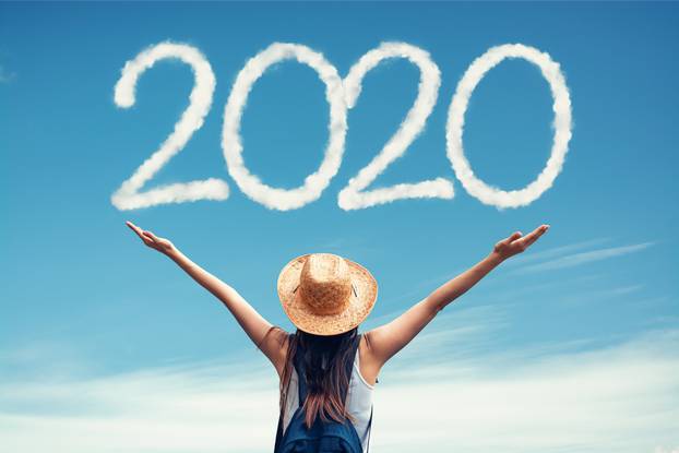 Beautiful woman greets the 2020 portrayaled with clouds