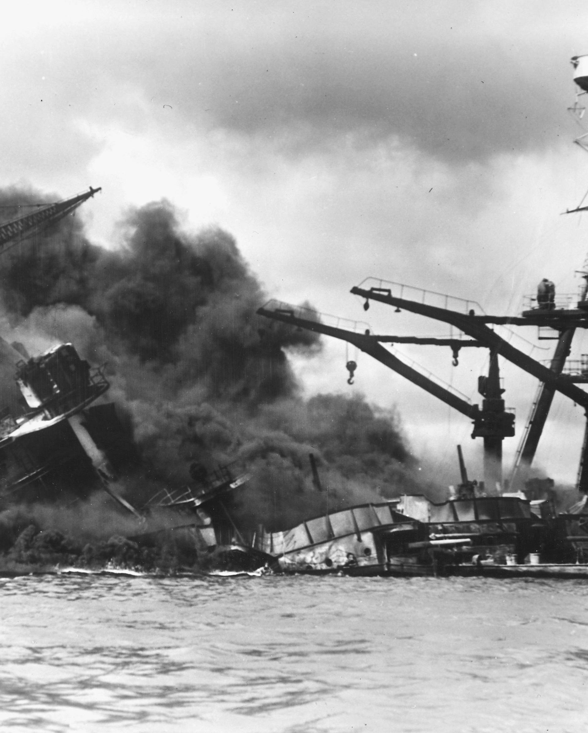 The battleship USS Arizona sinks after being hit by a Japanese air attack on Pearl Harbor