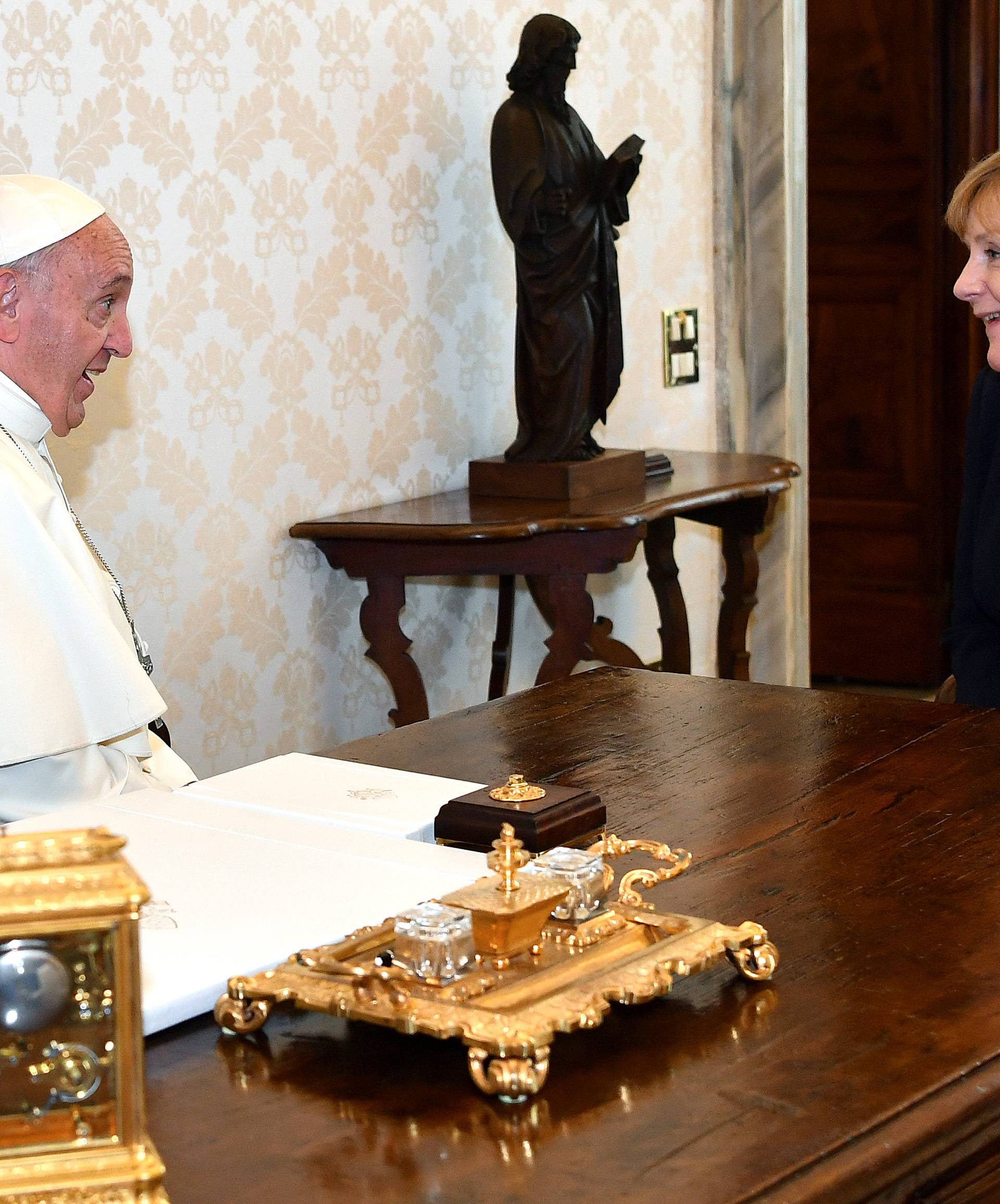 German Chancellor Angela Merkel talks with Pope Francis during a meeting at the Vatican