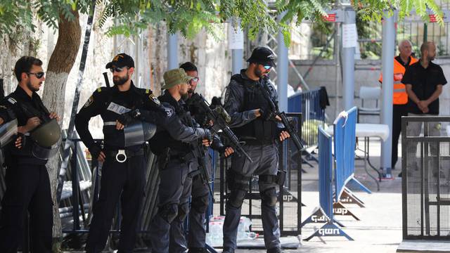 Israeli police officers stand guard next to recently installed metal detectors at an entrance to the compound known to Muslims as Noble Sanctuary and to Jews as Temple Mount in Jerusalem's Old City