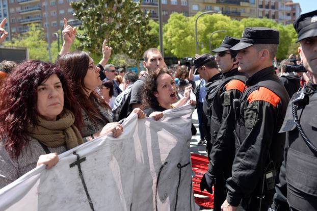 Protesters break through a police line after a nine-year sentence was given to five men accused of the multiple rape of a woman during Pamplona