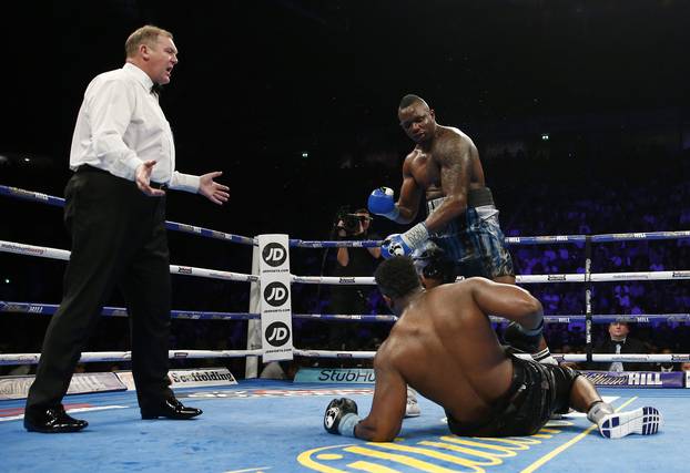 Dilian Whyte stands over Dereck Chisora after he slips over
