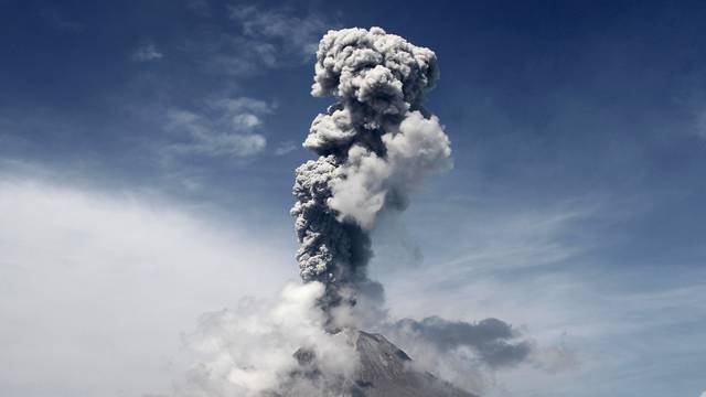 Mount Sinabung volcano, active since 2010, spews smoke and ash into the air during an eruption as seen from Sukandebi village, Karo, North Sumatra