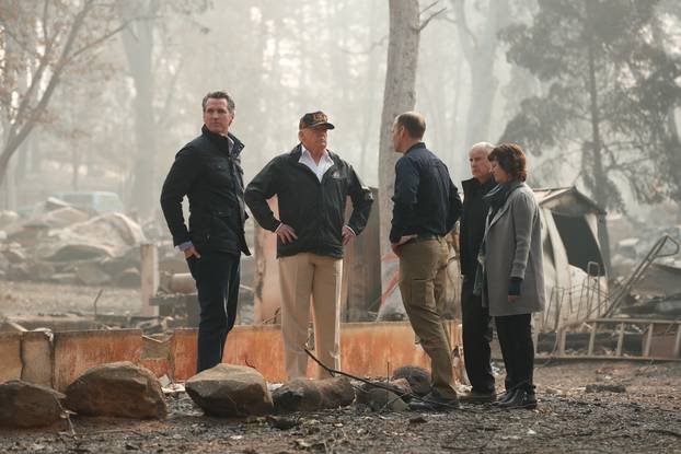 President Donald Trump visits the charred wreckage of Skyway Villa Mobile Home and RV Park with Governor-elect Gavin Newsom FEMA head Brock Long Paradise Mayor Jody Jones and Governor Jerry Brown in Paradise California