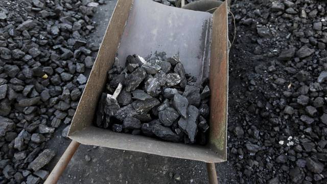 FILE PHOTO: Bad quality coal is picked out at local businessman Sun Meng's small coal depot near a coal mine of the state-owned Longmay Group on the outskirts of Jixi, Heilongjiang, China