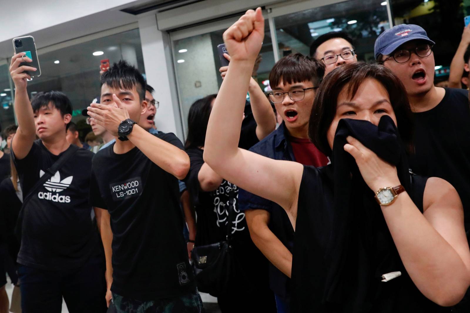 Anti-government protesters shout during a protest at a shopping mall in Tai Po, Hong Kong